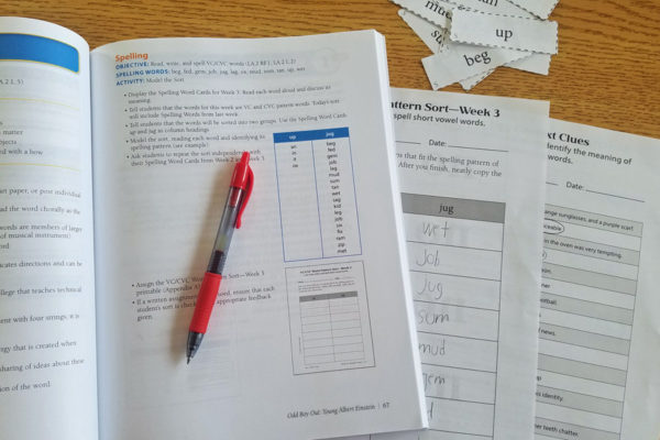 Homeschool manual and worksheets laid out on a table