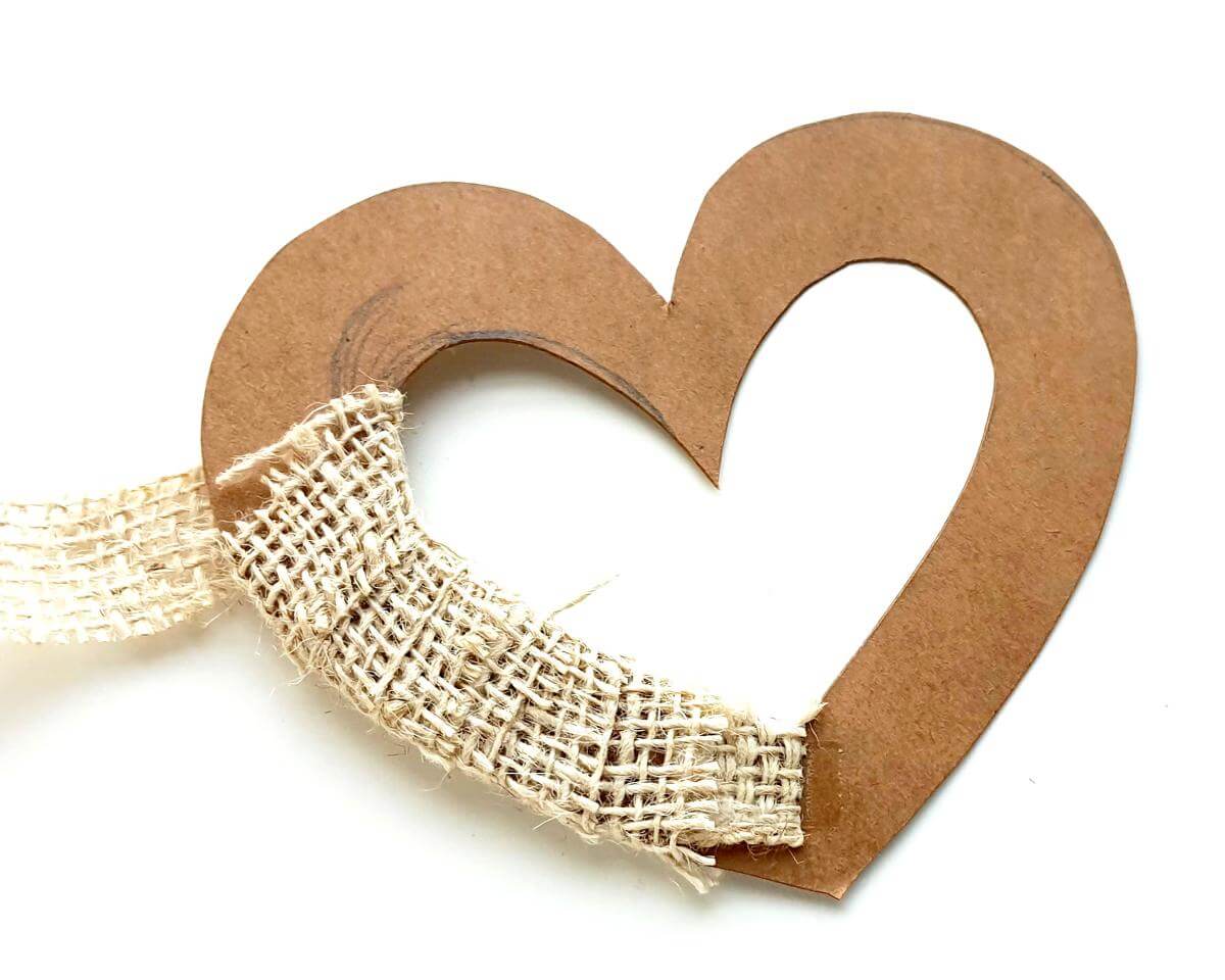 Image of brown heart shape partially wrapped with burlap lace