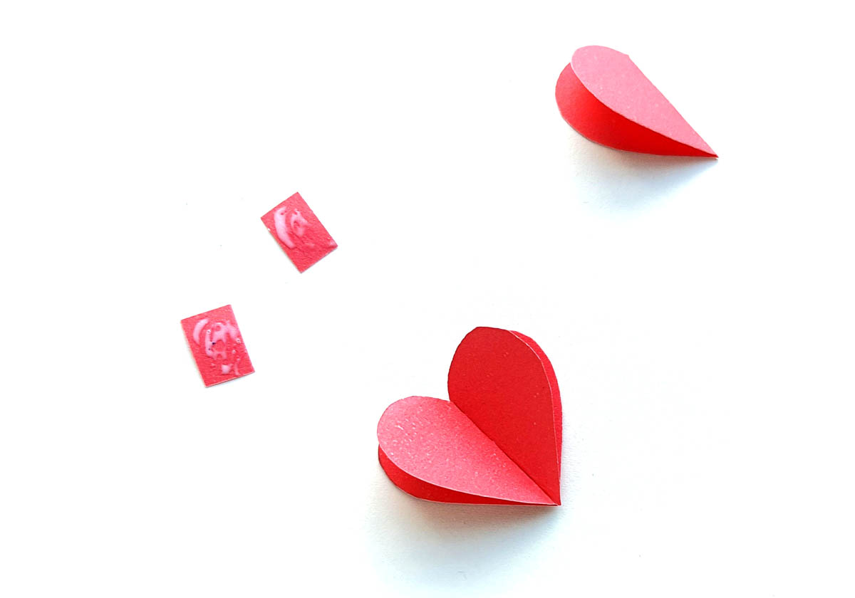 Image of 2 red paper hearts and 2 red paper rectangles waiting to be glued together