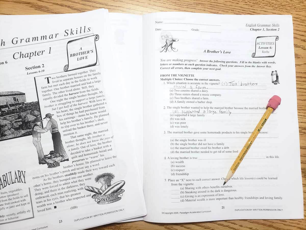 Image of open English workbook lying on a table with a pencil
