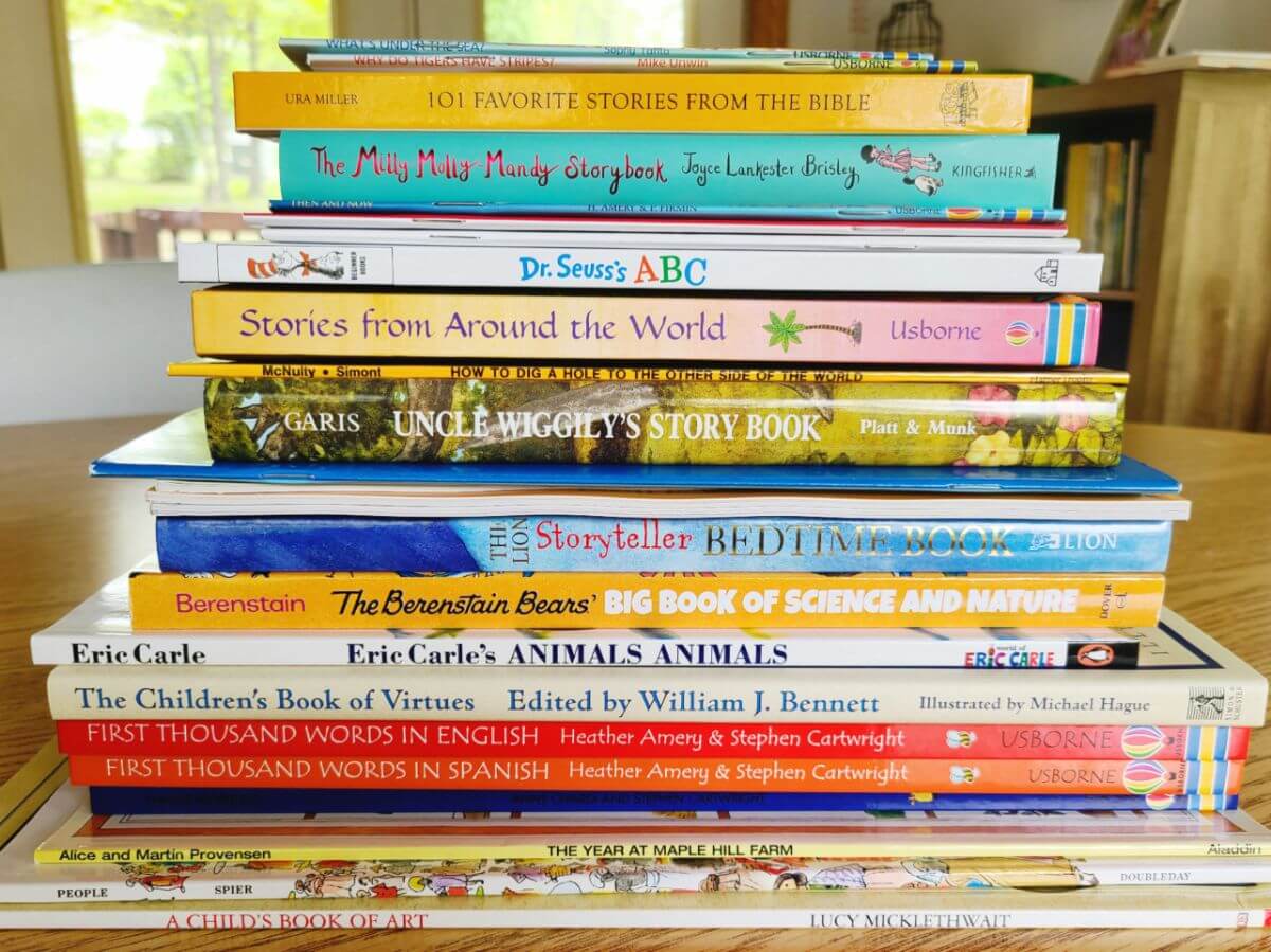 Image of a large stack of children's books on a schoolroom table