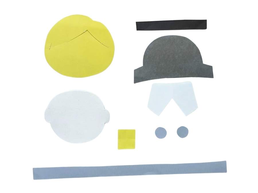 Image of pieces of yellow, white, gray, and black paper on a white background.