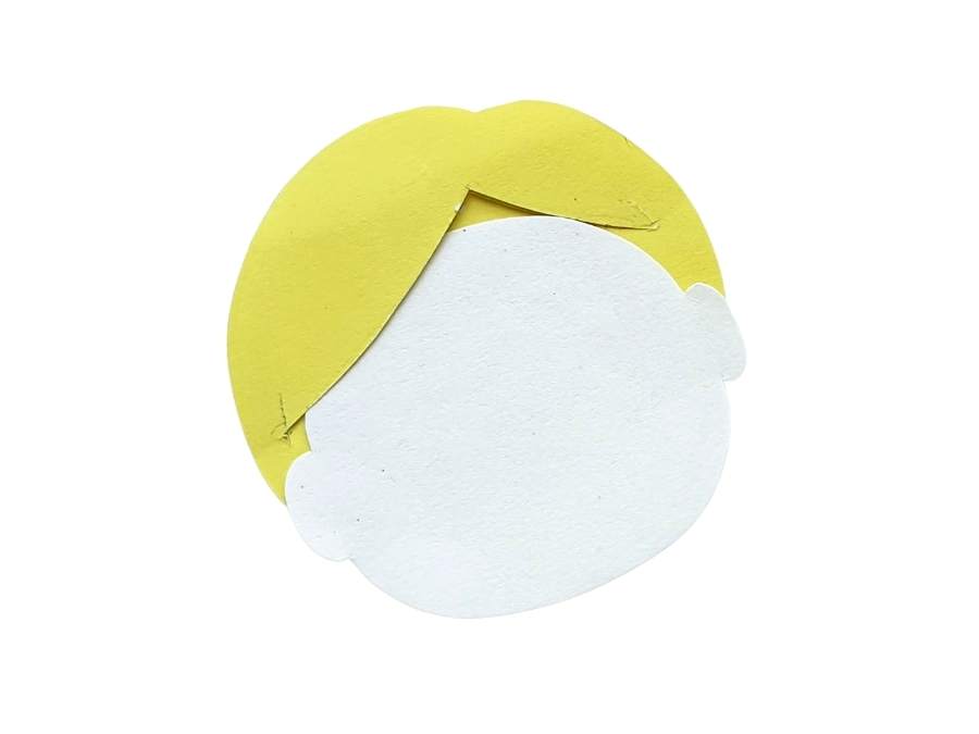 Image of white construction paper face with yellow paper hair on white background.