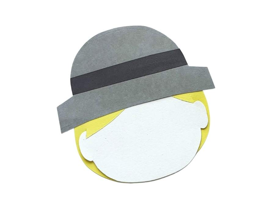 Image of Pilgrim's head constructed of white paper with yellow paper hair and a gray and black paper hat.