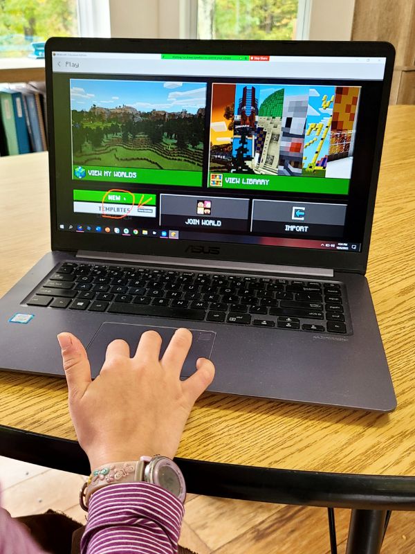 Image of a laptop showing an online coding class using Minecraft Education Edition for kids