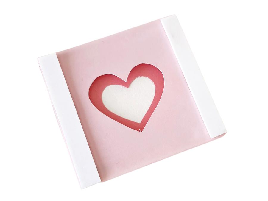 Image of 2 layers of a 3D heart in shades of pink, with white foam strips on the edges to attach a third layer.