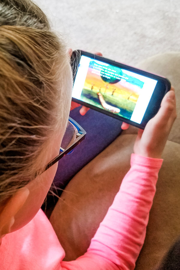 Image of young girl using an app for teaching kids Spanish at home.