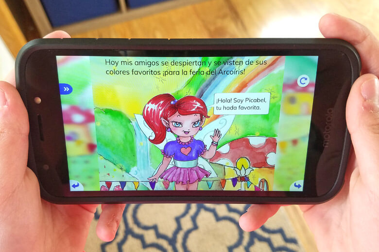 Image of girl's hands holding a phone and using and app to teach kids Spanish.