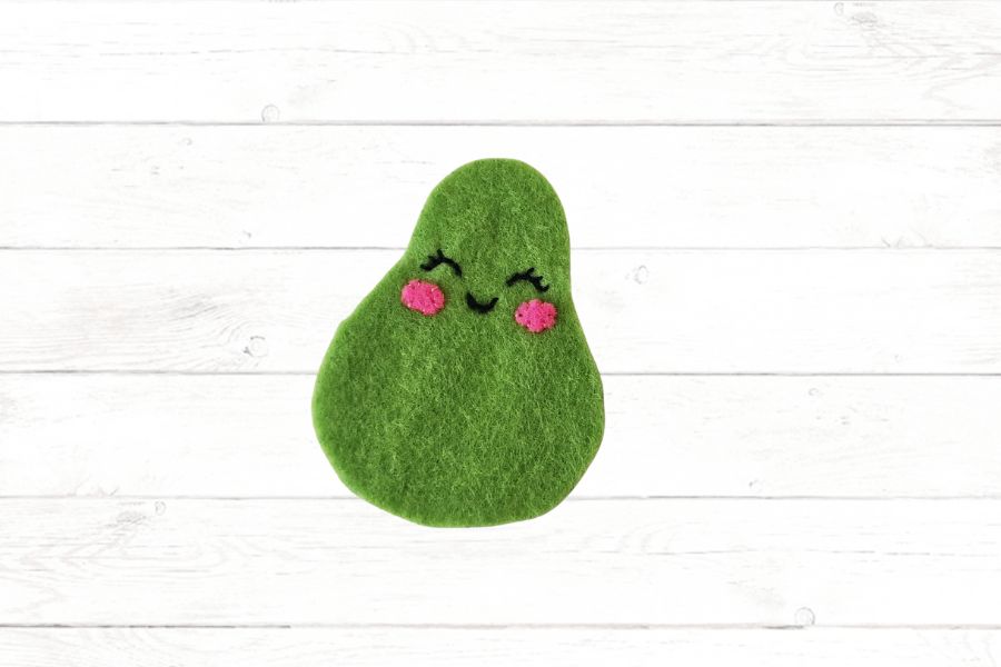 Felt crafting for kids Image of a felt piece shaped like an avocado with a face stitched on.